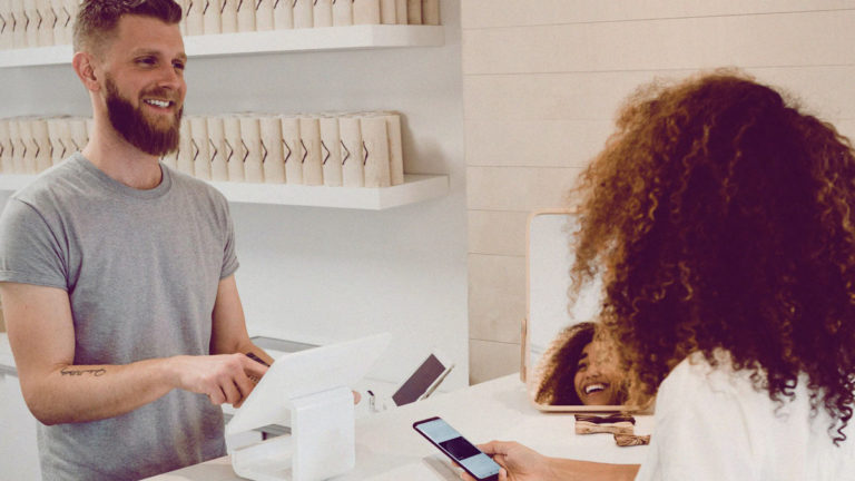 Sales person interacting with customer in retail store