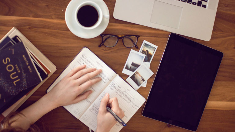 Home office business planning in wooden desk with notepad