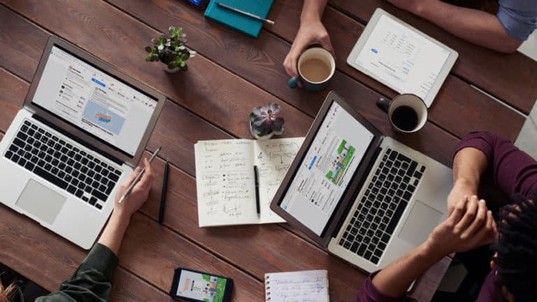 a group of people using their laptops to find tips to increasing donations during online campaigns