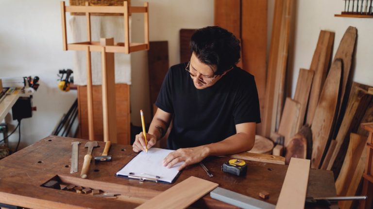 guy sitting at his desk filling in his invoice template