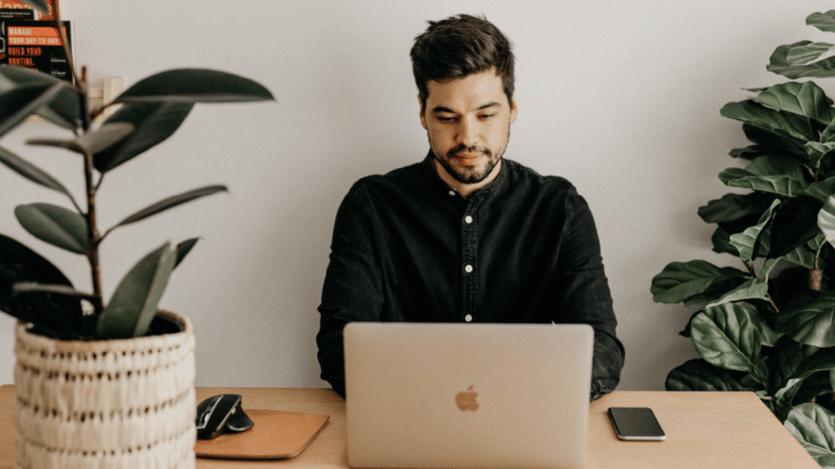 A person sitting at a desk, writing content for his small business blog