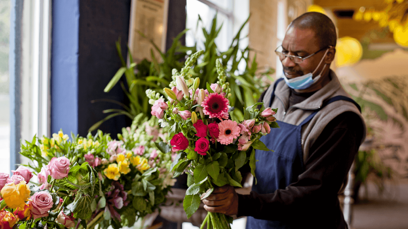 An employee of the Flower Cafe making a bouquet