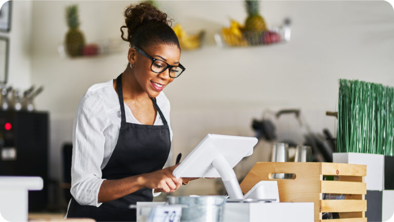 A sales woman working at a Point of Sale device