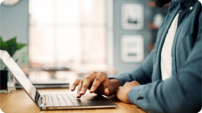 A man sitting at a desk working on his laptop