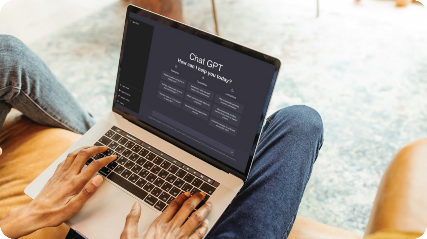 An image of a person sitting with a laptop using the AI technology, ChatGPT