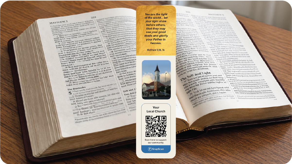 An open bible with a bookmark that contains a QR code for congregants to donate